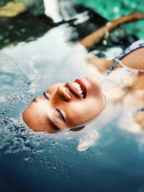 A lady relaxing outdoors while sunbathing under warm sunlight.