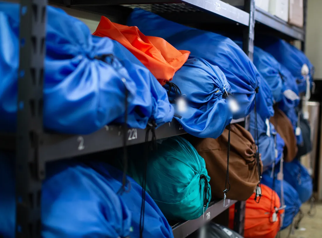 Tagged laundry bags on numbered shelves at the Freshly Folded facility